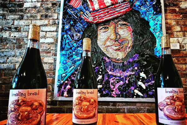 Bottles of wine in front of a painting